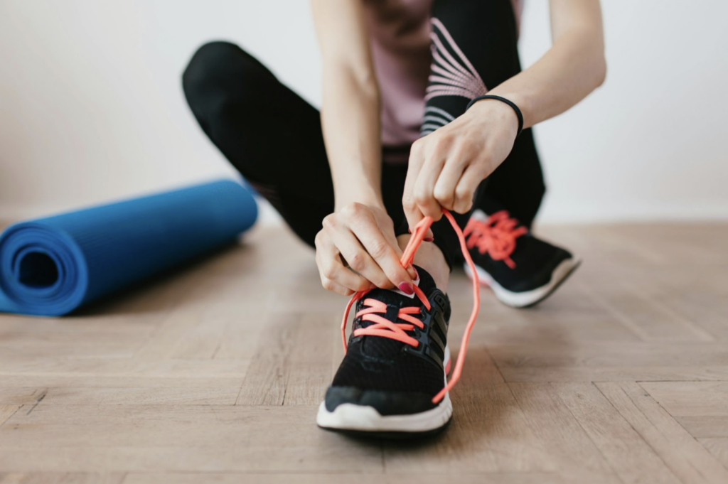 Woman tying her shoes 