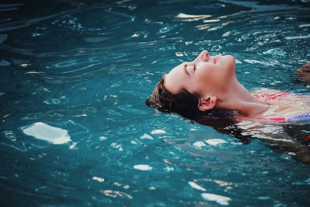 Relaxed woman floating in the pool