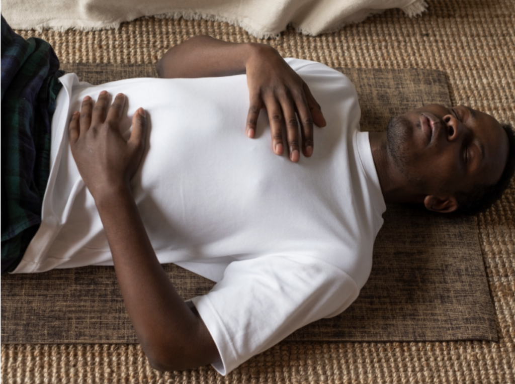 man lying on ground breathing